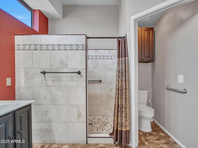 11547 W King Snake Ct, Surprise, AZ 85378 - bathroom featuring toilet, a tile shower, vanity, and baseboards