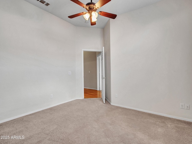 11547 W King Snake Ct, Surprise, AZ 85378 - empty room with light colored carpet, ceiling fan, and baseboards