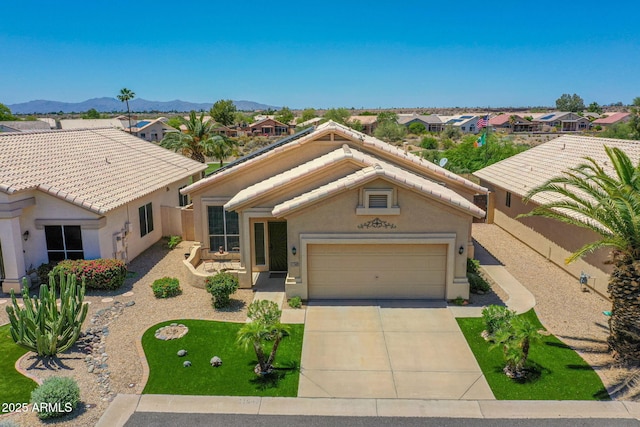 11547 W King Snake Ct, Surprise, AZ 85378 - view of front of property featuring a tiled roof, concrete driveway, and stucco siding