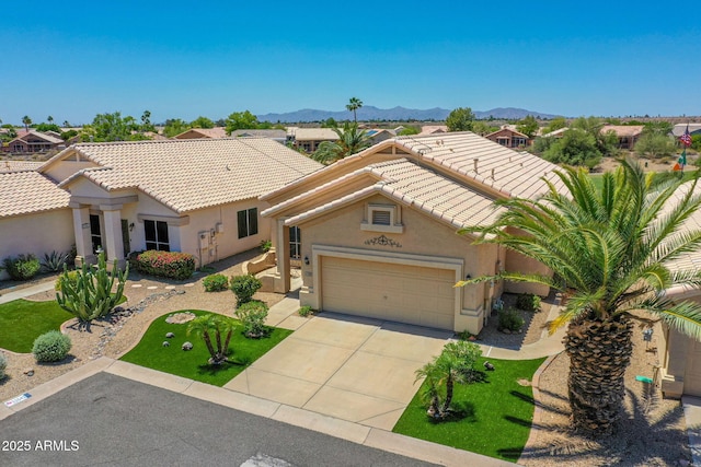 11547 W King Snake Ct, Surprise, AZ 85378 - mediterranean / spanish home with stucco siding, driveway, a tile roof, and a garage