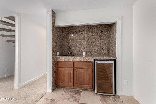 bar with light colored carpet, beverage cooler, and sink