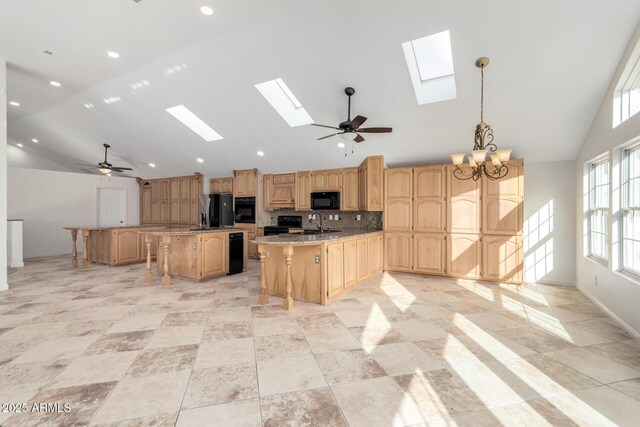 kitchen with pendant lighting, high vaulted ceiling, tasteful backsplash, a center island, and black appliances