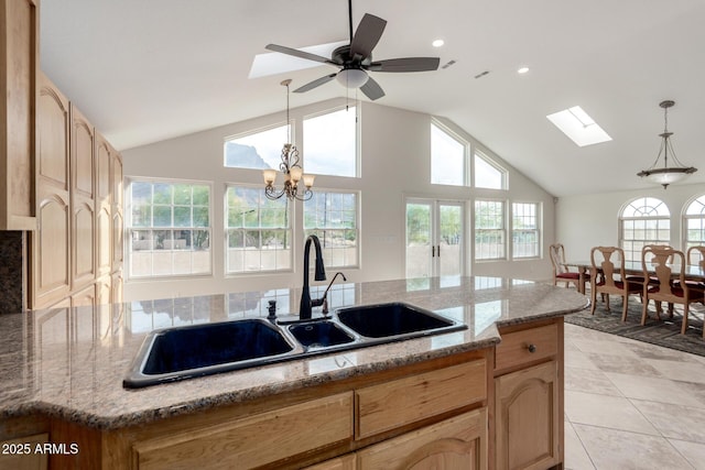 kitchen with pendant lighting, sink, a center island with sink, and a wealth of natural light