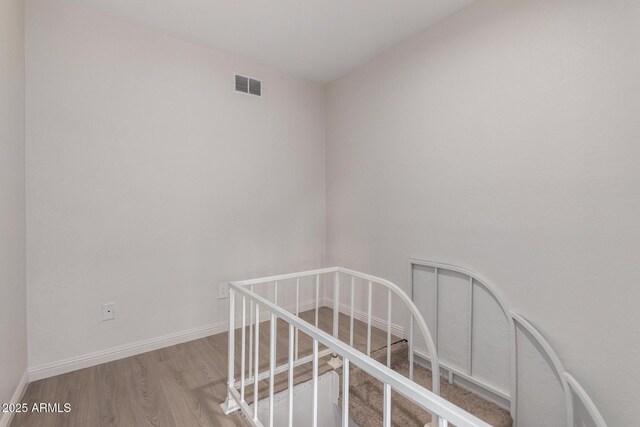 staircase with wood-type flooring