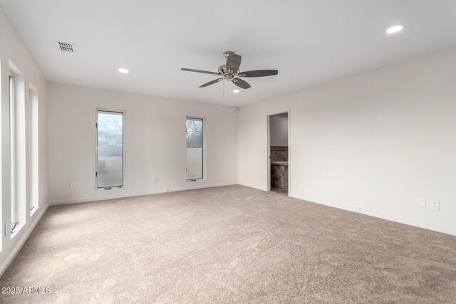 carpeted spare room featuring ceiling fan