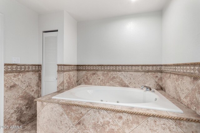 bathroom with a relaxing tiled tub