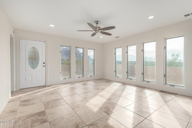 interior space featuring light tile patterned floors and ceiling fan