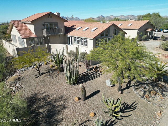 exterior space with a mountain view and a balcony