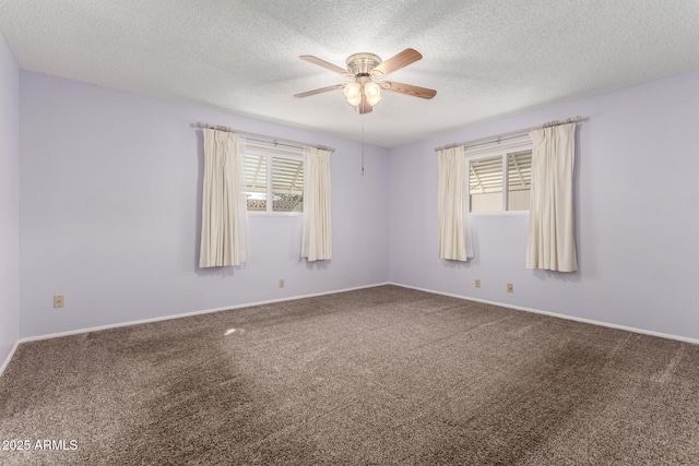 carpeted empty room featuring a healthy amount of sunlight, ceiling fan, and a textured ceiling