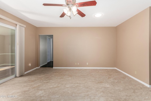 unfurnished room featuring a ceiling fan and baseboards