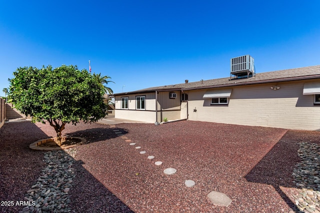 back of property featuring central air condition unit, a patio area, fence, and brick siding