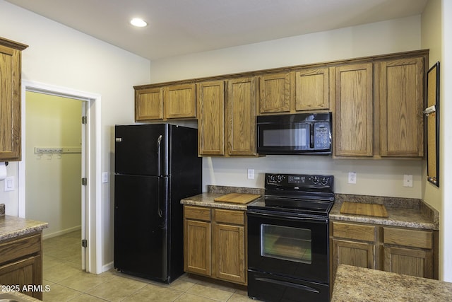 kitchen featuring light tile patterned floors and black appliances