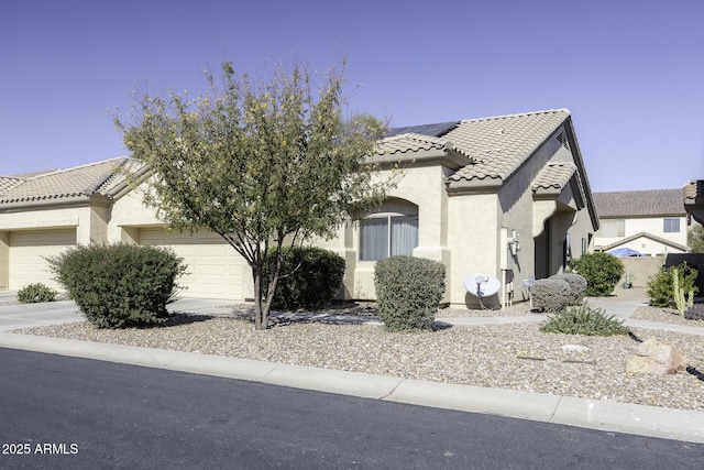 view of front of home with a garage and solar panels