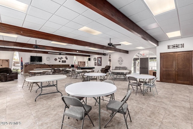 131 N Higley Rd Unit 117, Mesa, AZ 85205 - dining area featuring beam ceiling, ceiling fan, a drop ceiling, plenty of natural light, and light tile patterned floors