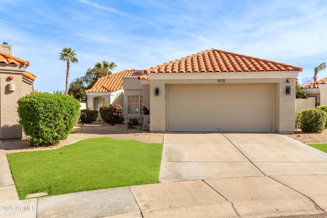 mediterranean / spanish house featuring driveway, a tiled roof, a front yard, stucco siding, and an attached garage