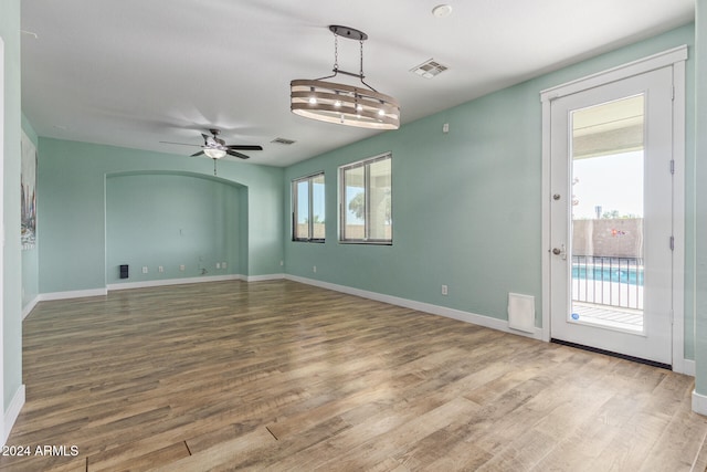 empty room with wood-type flooring and ceiling fan