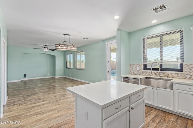 kitchen featuring a wealth of natural light, light hardwood / wood-style flooring, and white cabinets