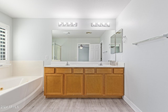 bathroom featuring vanity, ceiling fan, hardwood / wood-style flooring, and separate shower and tub