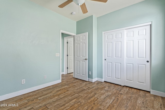 unfurnished bedroom with a closet, wood-type flooring, and ceiling fan