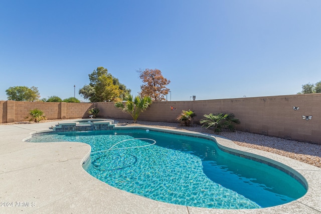 view of pool featuring a patio area and an in ground hot tub