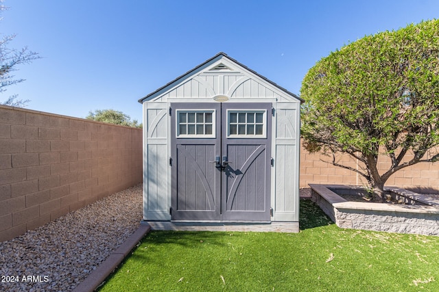 view of outbuilding with a lawn