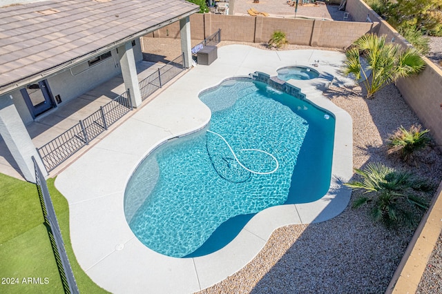 view of pool with an in ground hot tub and a patio area