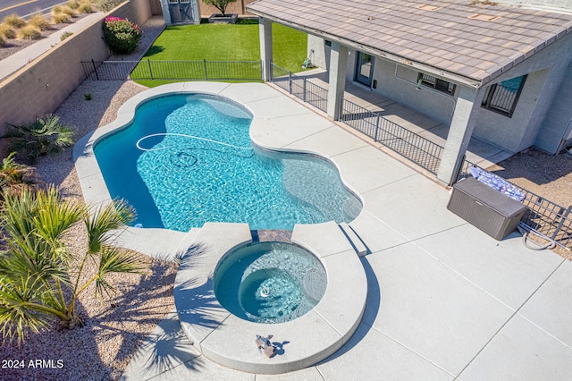 view of pool with a yard, a patio area, and an in ground hot tub