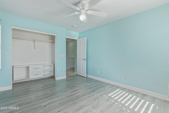 unfurnished bedroom featuring a closet, light wood-type flooring, and ceiling fan