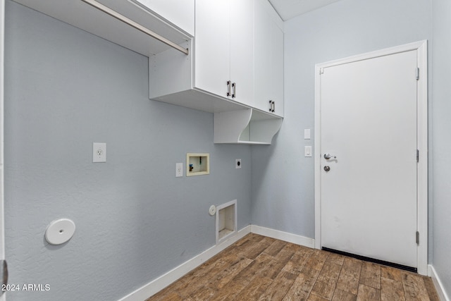 washroom with hookup for an electric dryer, dark wood-type flooring, washer hookup, and cabinets