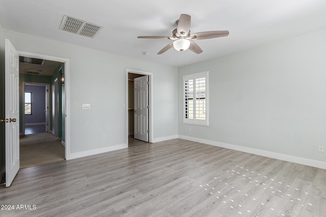 unfurnished bedroom featuring light wood-type flooring and ceiling fan