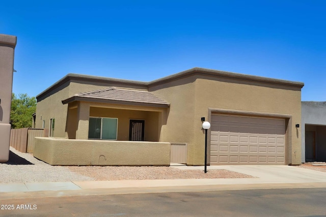 728 S Meadowood Ln, Sierra Vista, AZ 85635 - view of front of property featuring a fenced front yard, stucco siding, an attached garage, and driveway