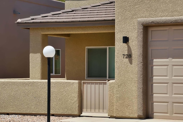 728 S Meadowood Ln, Sierra Vista, AZ 85635 - doorway to property with stucco siding and a tile roof