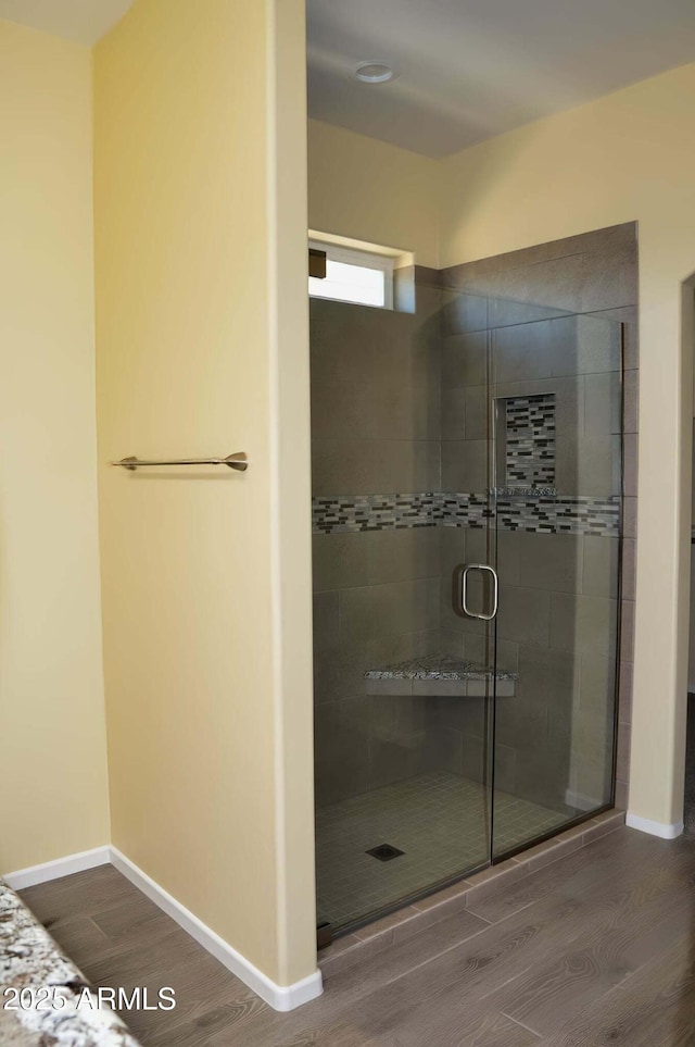 728 S Meadowood Ln, Sierra Vista, AZ 85635 - bathroom featuring wood finished floors, a shower stall, and baseboards