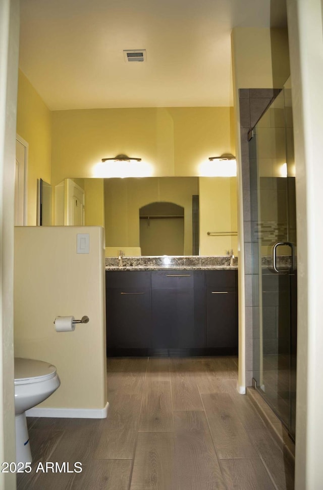 728 S Meadowood Ln, Sierra Vista, AZ 85635 - full bath with double vanity, a stall shower, toilet, and wood finished floors