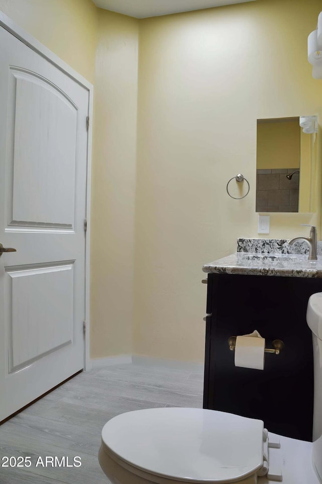 728 S Meadowood Ln, Sierra Vista, AZ 85635 - bathroom featuring toilet, wood finished floors, and vanity