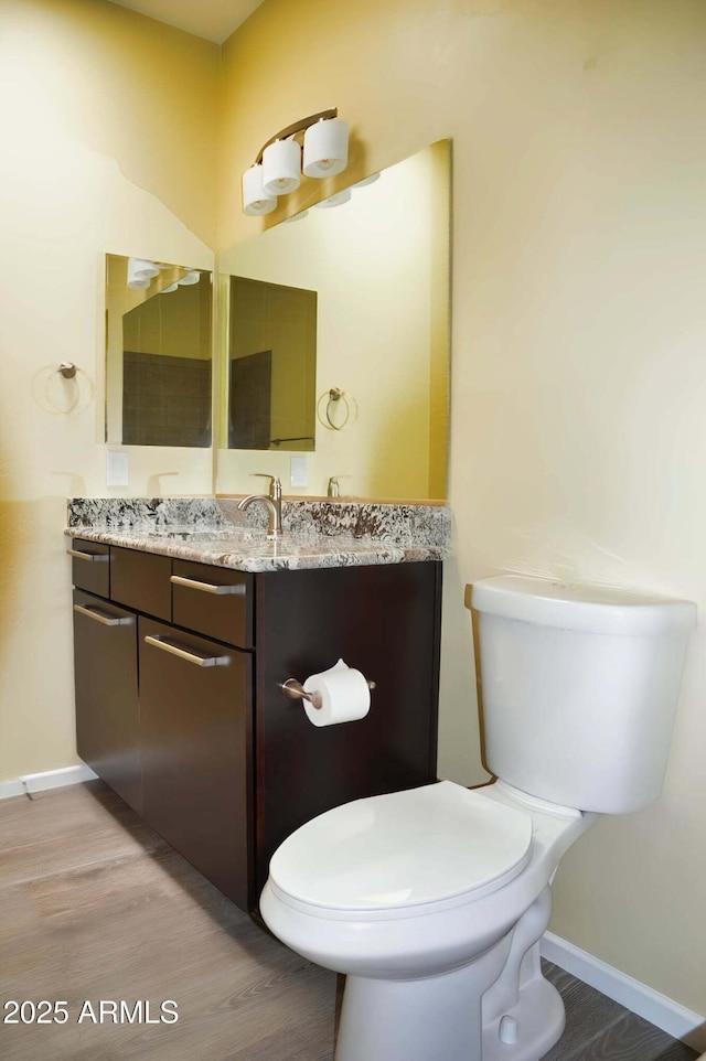 728 S Meadowood Ln, Sierra Vista, AZ 85635 - bathroom featuring vanity, toilet, baseboards, and wood finished floors