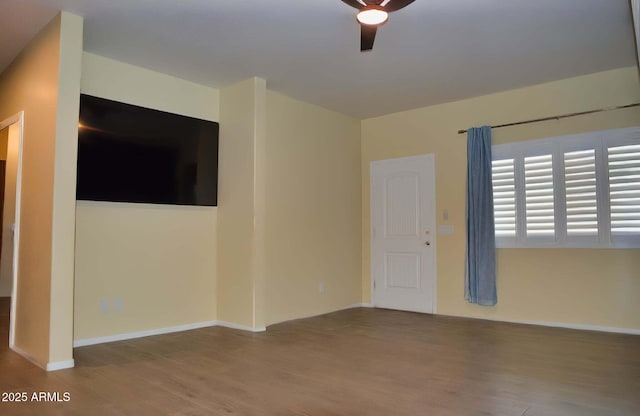 728 S Meadowood Ln, Sierra Vista, AZ 85635 - unfurnished room with wood finished floors, a ceiling fan, and baseboards