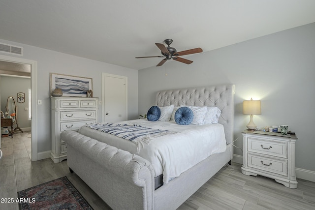 bedroom with ceiling fan and light hardwood / wood-style flooring