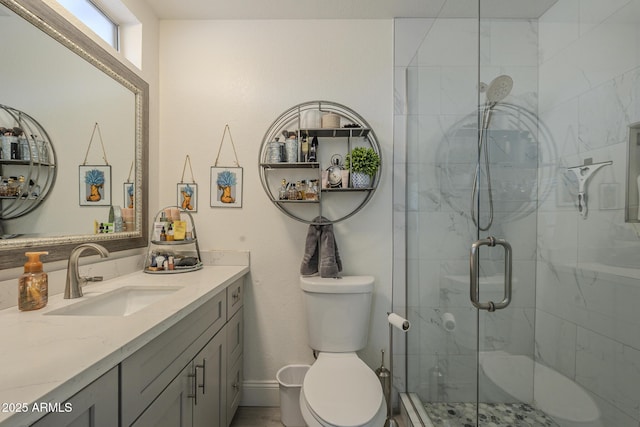 bathroom with toilet, vanity, and walk in shower