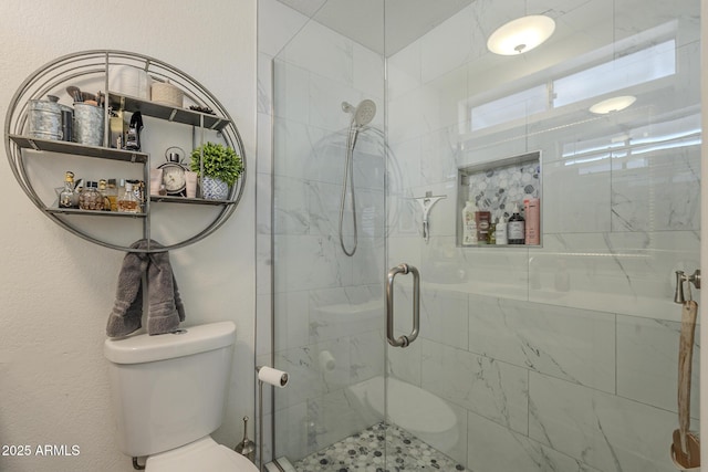 bathroom featuring toilet and walk in shower