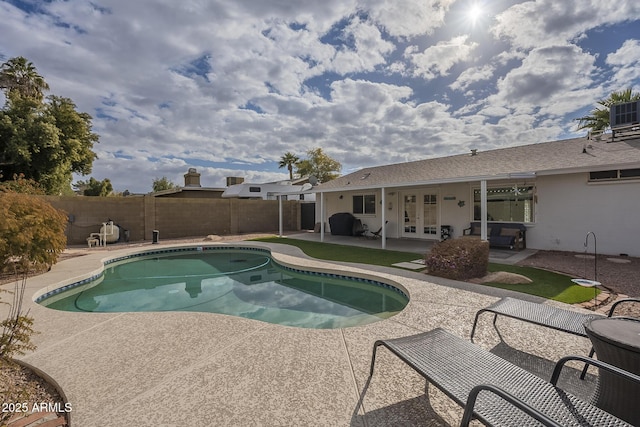 view of pool with a patio area and french doors