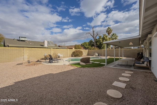 view of yard featuring a fenced in pool, central AC, and a patio