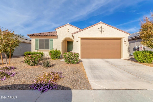 mediterranean / spanish-style home featuring a garage