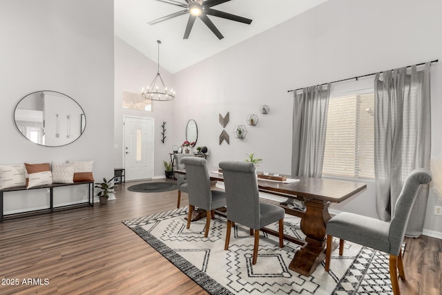 dining area featuring baseboards, high vaulted ceiling, wood finished floors, and a notable chandelier