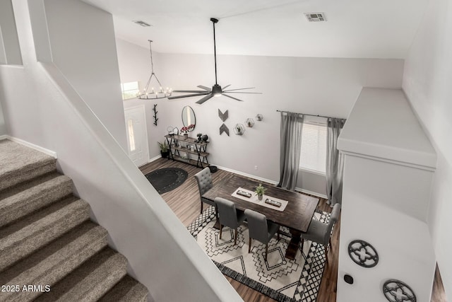 interior space with high vaulted ceiling, ceiling fan with notable chandelier, wood finished floors, visible vents, and baseboards