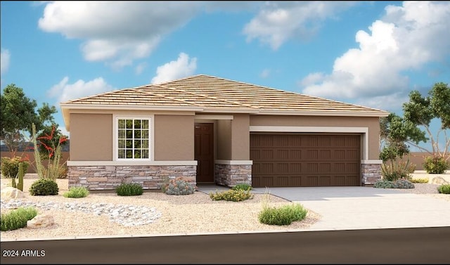 view of front of house featuring concrete driveway, an attached garage, stone siding, and stucco siding