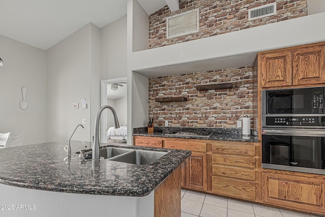 1207 E Clearview Dr, Casa Grande, AZ 85122 - kitchen featuring oven, high vaulted ceiling, built in microwave, brown cabinets, and a sink