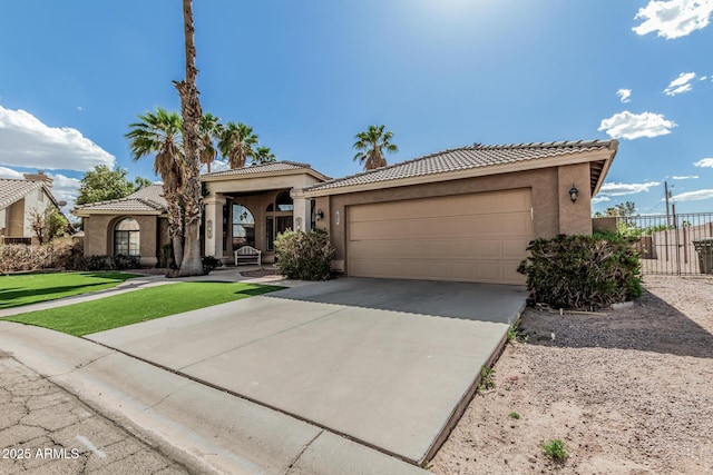1207 E Clearview Dr, Casa Grande, AZ 85122 - mediterranean / spanish-style house featuring concrete driveway, stucco siding, an attached garage, and a tiled roof