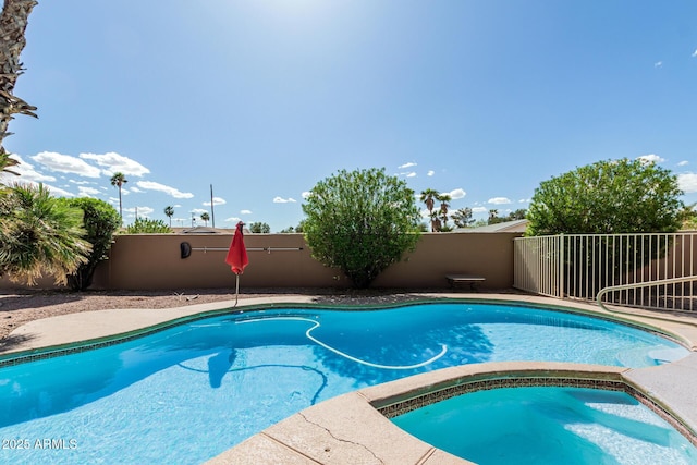 1207 E Clearview Dr, Casa Grande, AZ 85122 - view of swimming pool featuring fence and a pool with connected hot tub