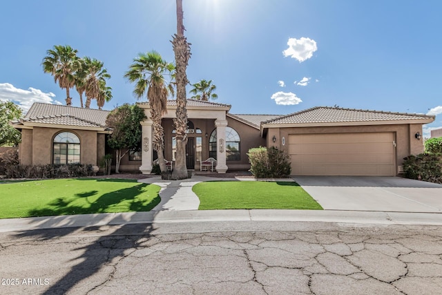 1207 E Clearview Dr, Casa Grande, AZ 85122 - mediterranean / spanish house with a tile roof, a front yard, concrete driveway, an attached garage, and stucco siding
